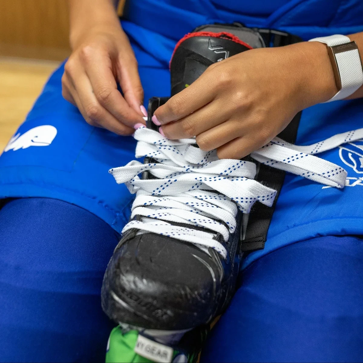 Howies thick white cloth hockey laces threaded through skate eyelets