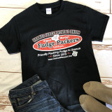 Black Uranus Fudge Packer t-shirt laid flat next to jeans and boots.