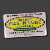 A rectangular white souvenir magnet for the "Uranus Gas 'N Lube Company." The center features a yellow oval logo, while the top and bottom are printed with the cheeky slogans: "We Pump It in the Front" and "and Lube It in the Rear." At the very bottom, it reads "On Historic Route 66" with a small Route 66 shield icon.