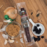 Cherry chipotle beef strip package surrounded by cherries and brown sugar from Uranus Fudge Factory.