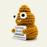 Yellow crocheted Emotional Support Poop holding a Nothing Beats Uranus sign, side angle