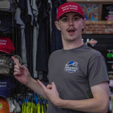 Man wearing the red Make Uranus Great Again hat in the apparel section at Uranus General Store.