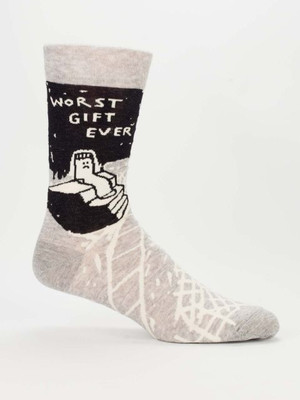 A single light heather grey crew sock displayed against a plain white background. Knit into the ankle is a large black rectangular block. Inside the black block, a small, sad white sock with a frowny face sits inside an open gift box. Above it, white text reads: "WORST GIFT EVER". The foot section of the sock features an abstract, messy pattern of overlapping white lines resembling a web or cracked ice.