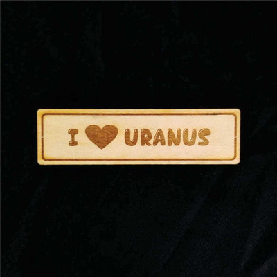 Wooden rectangular magnet featuring an engraved I Heart Uranus from Uranus Fudge Factory.