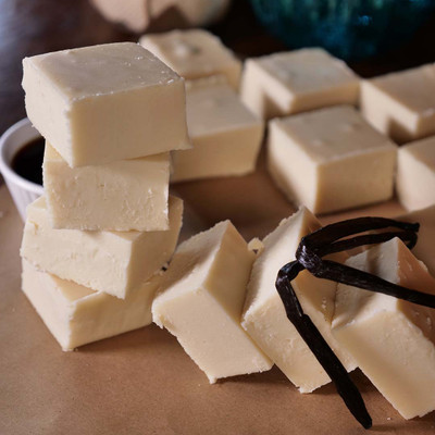 Vanilla Fudge from Uranus stacked on a wooden tabletop with some vanilla beans.
