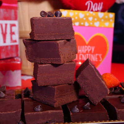Dark Chocolate Fudge from Uranus stacked in a pile with Valentine decorations behind it