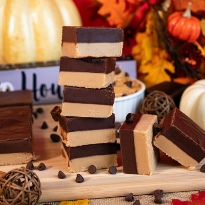 Peanut Butter Chocolate fudge from Uranus stacked on a cutting board with fall decor. Peanut Butter Chocolate fudge from Uranus stacked on a cutting board with fall decor.