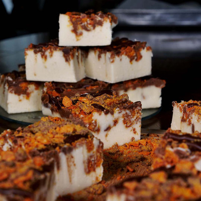 A tempting pile of Vanilla Fudge with Butterfinger pieces, freshly handcrafted at the famous Uranus Fudge Factory.