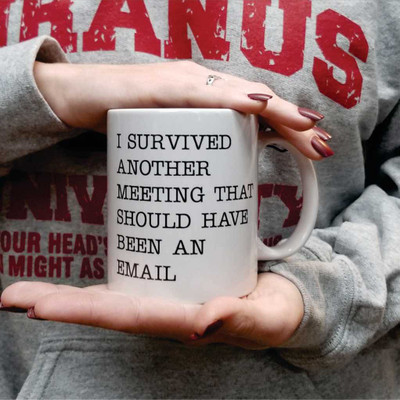 Person holding a white coffee mug with a funny meeting that should have been an email quote.