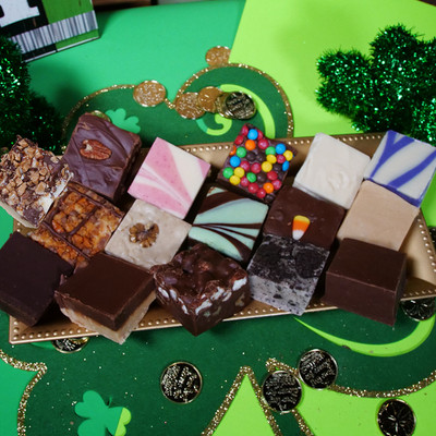 Big Package sampler pack with sixteen fudge flavors on a gold platter with St. Patrick's Day decor