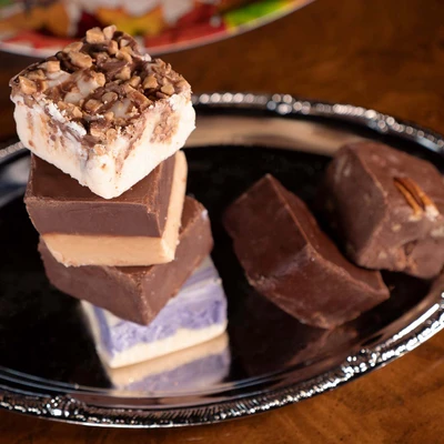 Taste of Uranus sampler pack with six fudge flavors on a holiday silver tray 
