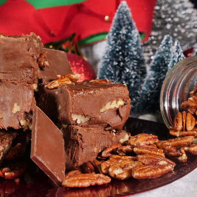 Reduced Sugar Chocolate Pecan Fudge From Uranus on a plate with Christmas decor