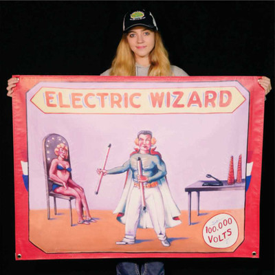 Electric Wizard sideshow banner featuring an electrified man, displayed for scale at the Uranus Sideshow Museum