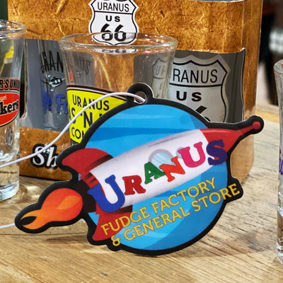 Chocolate fudge scented air freshener featuring the main logo from Uranus Fudge Factory
