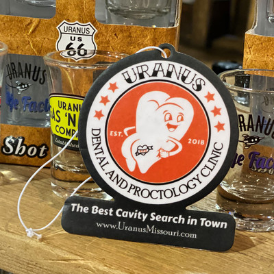 Bubblegum scented car air freshener featuring the Dental and Proctology Clinic logo from Uranus Fudge Factory
