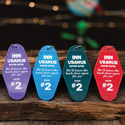 "Inn Uranus Hotel" plastic vintage-style keychains in all four colors from Uranus Fudge Factory