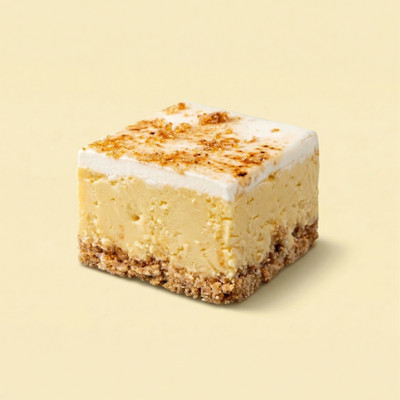 A square of Uranus Lemon Meringue Pie Fudge against a pastel yellow background.