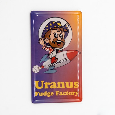 Front view of the 2x3 Rex Uranus magnet with glossy domed finish, showing Rex the bearded astronaut mascot riding the URANU$ rocket above the "Uranus Fudge Factory" name in yellow.