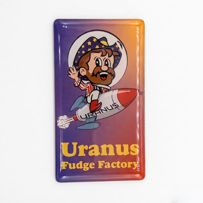 Front view of the 2x3 Rex Uranus magnet with glossy domed finish, showing Rex the bearded astronaut mascot riding the URANU$ rocket above the "Uranus Fudge Factory" name in yellow.