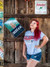A person modeling the gray Uranus Fudge Packer Union t-shirt in a rustic barn setting.