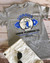Gray Uranus Plumbing Co novelty t-shirt laid flat from Uranus Fudge Factory