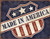 Distressed vintage style metal sign featuring an American flag shield design with Made In America text.