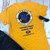 Gold Uranus Space Force novelty t-shirt laid flat from Uranus Fudge Factory