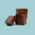 4-piece stack of Uranus Chocolate Fudge against a turquoise background. 