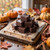 Stacked dark chocolate fudge squares on a wood board with fall pumpkins and cinnamon sticks