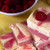 Layered raspberry fudge cubes topped with a fresh berry by Uranus Fudge Factory.