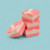 3 piece stack of Uranus Raspberry Vanilla Fudge against a turquoise background. 