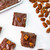 Top view of Chocolate Pecan Fudge from Uranus Fudge Factory by a pile of pecans