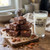 Chocolate pecan fudge squares with a Uranus General Store glass of milk on a farmhouse table