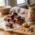 Chocolate peanut butter fudge squares next to a jar of Uranus General Store peanut butter