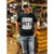 Person wearing a black Straight Outta Uranus novelty t-shirt