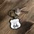 Keys attached to a Uranus Route 66 shield novelty keychain on a rustic wooden table background Uranus Fudge Factory.