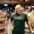 Smiling woman in a dark green novelty t-shirt with a humorous shits and giggles quote.
