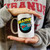 Person holding a white novelty coffee mug with a retro space rocket logo print from Uranus Fudge Factory.