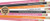 Close up layout of colorful novelty pencils with humorous procrastination quotes.
