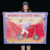 A person holding up a vintage style Monkey Scooter Rider carnival sideshow banner from Uranus Fudge Factory