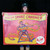 A person holding up a vintage-style Amazon Snake Charmer carnival sideshow banner from Uranus Fudge Factory
