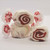 White and red swirled red velvet cake gourmet salt water taffy pieces stacked on a white background