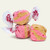 Brown and pink maple bacon gourmet salt water taffy pieces stacked against a plain white background