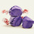 Purple gourmet grape salt water taffy pieces shown stacked against a plain white background