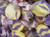 Purple and yellow striped saltwater taffy candies piled closely together by Uranus Fudge Factory.
