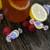 Raspberry lemonade saltwater taffy candies displayed with fresh fruit and a drink on a rustic wooden table.