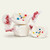 Three colorful wrapped Frosted Cupcake saltwater taffy candies stacked together on a plain white background by Uranus Fudge Factory.