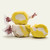 Three colorful wrapped buttered popcorn saltwater taffy candies stacked together on a plain white background by Uranus Fudge Factory.
