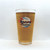 Beer-filled Uranus Fudge Factory & General Store pint glass isolated on a solid white background.