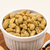 A bowl of Halipeen-Ya Dill Redneck Nutz seasons peanuts in a white bowl. 